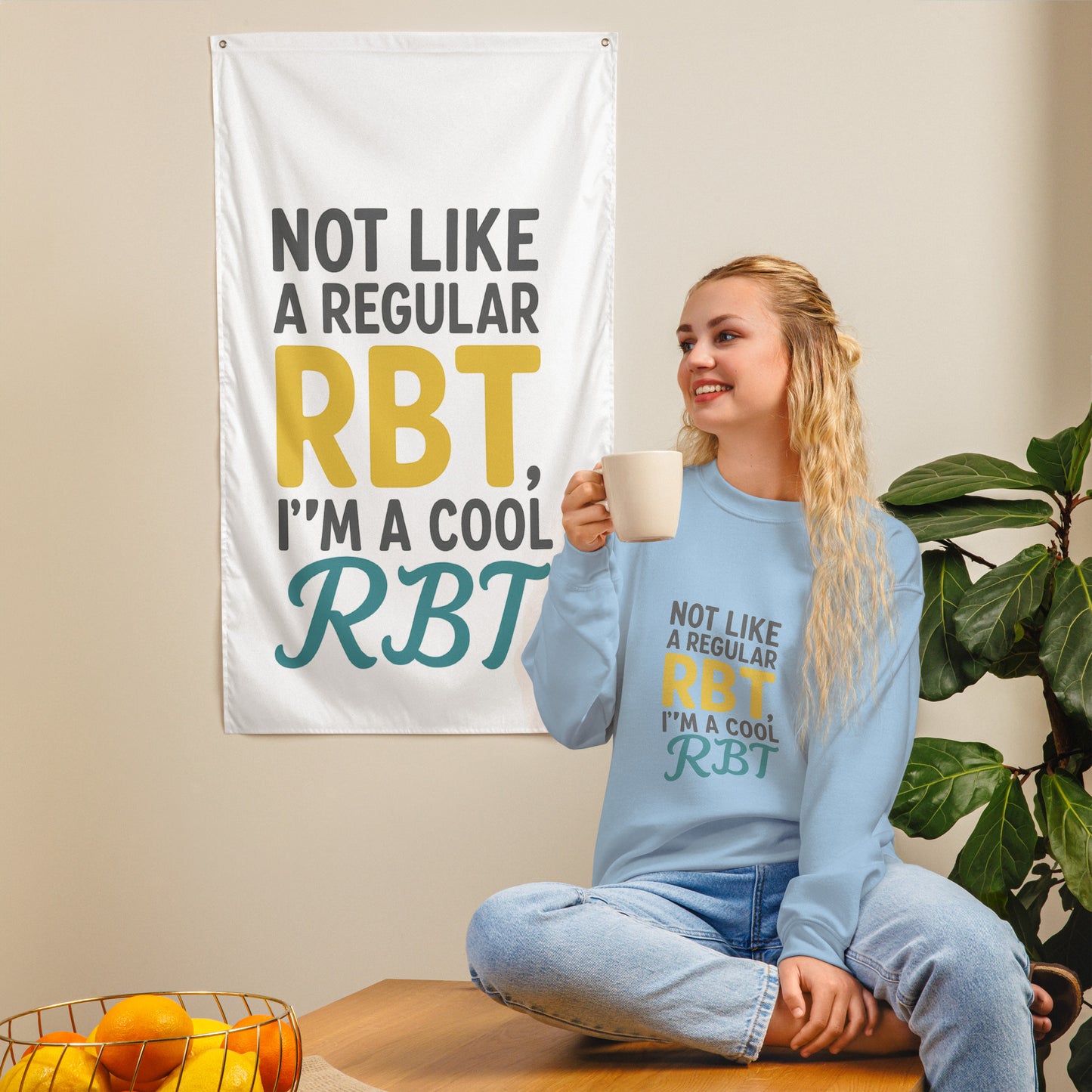 Light blue unisex sweatshirt with the quote ‘Not Like a Regular RBT, I’m a Cool RBT’ printed in bold yellow and teal letters. Comfortable crew neck sweater for Registered Behavior Technicians.